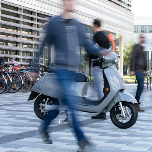 People in motion, Bicycles and an electro scooter.